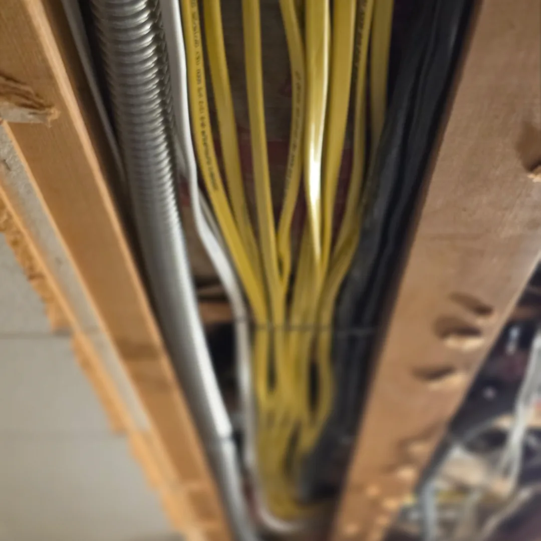 New branch circuit wiring routed through exposed framing during Seattle house rewiring