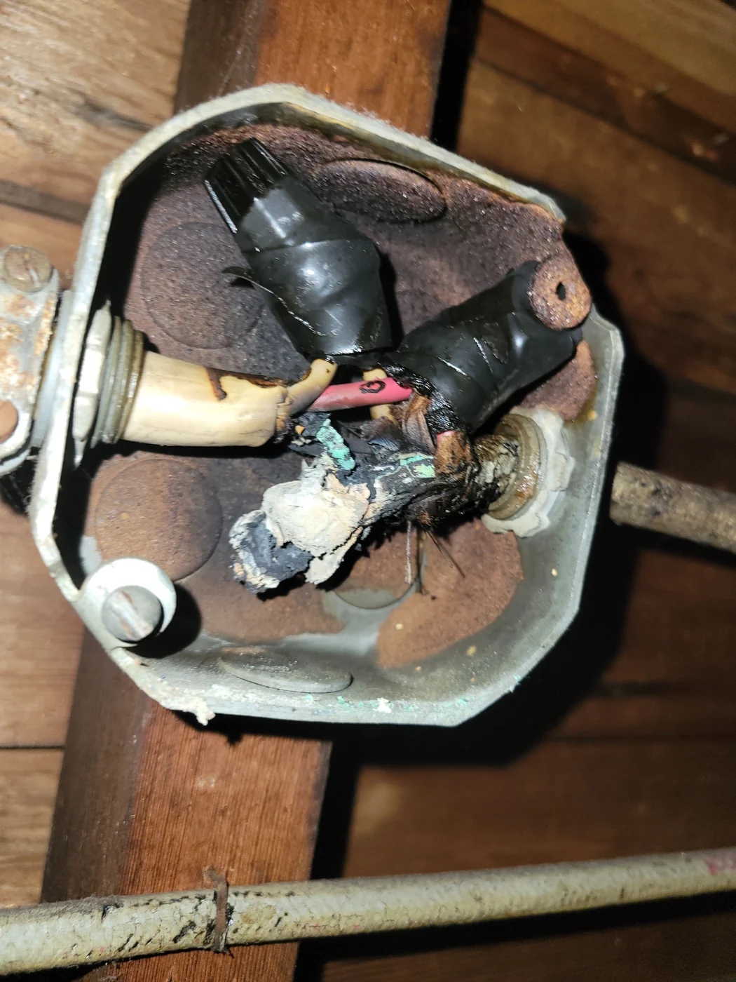 Damaged wire connections exposed in an electrical junction box during troubleshooting