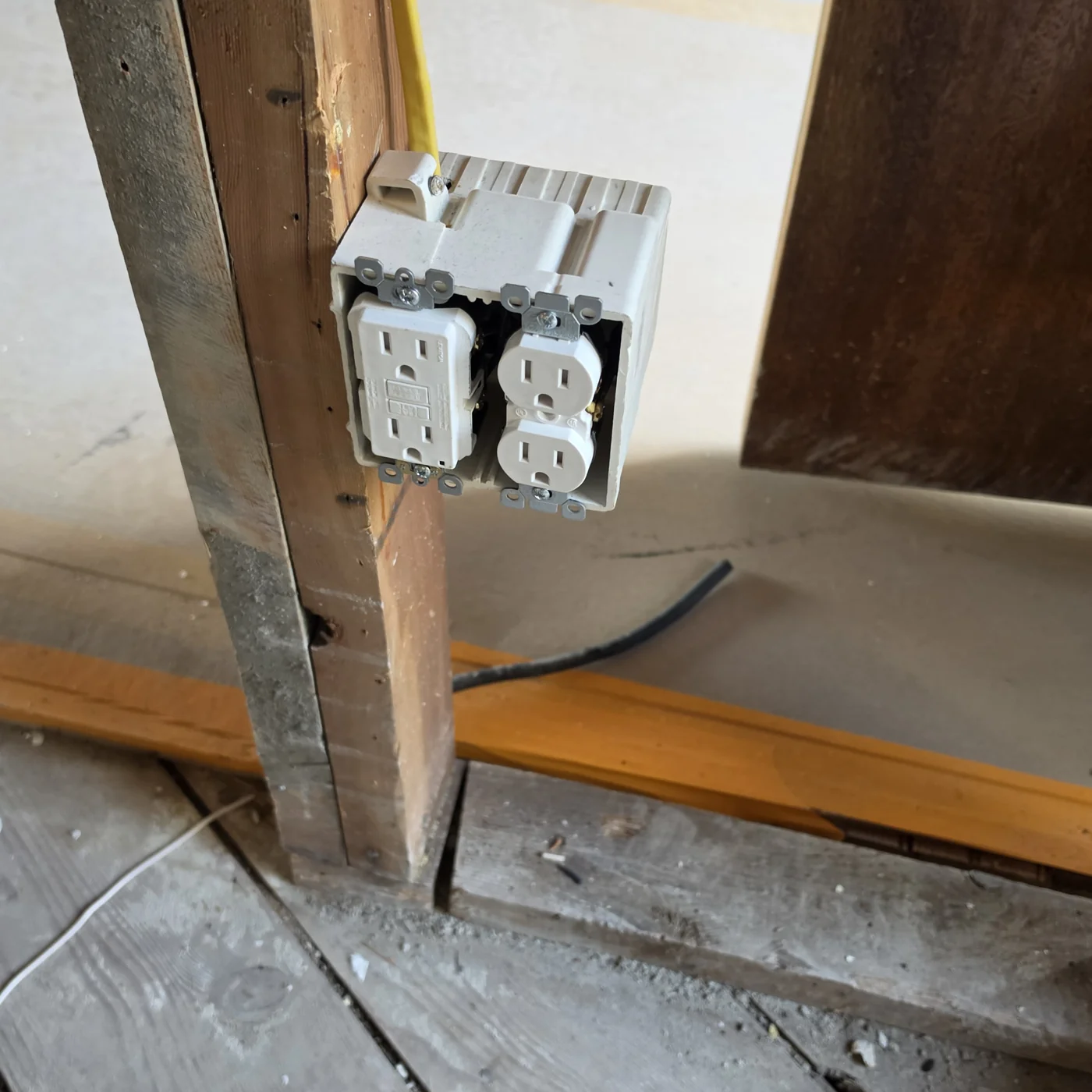 Newly mounted box with two receptacles during electrical work