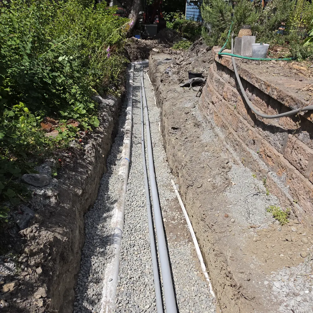 Underground electrical conduits laid in a trench for a home project